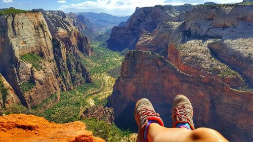 Low section of person on rock in mountains