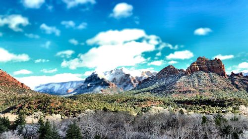 Scenic view of mountains against cloudy sky