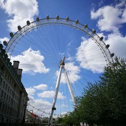 Low angle view of ferris wheel against sky