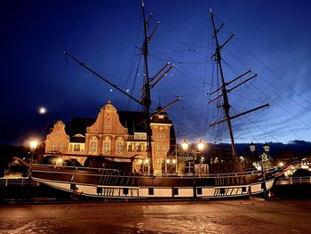 Sailboats in city at night