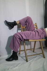 Low section of man sitting on chair
