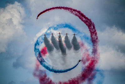 Low angle view of airshow against sky