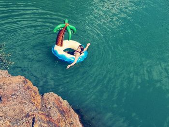 High angle view of woman floating on sea