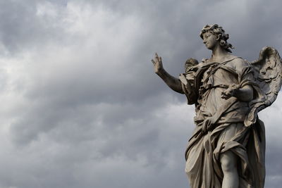 Low angle view of statue against sky