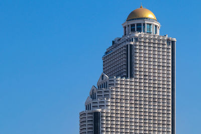 Top part of state tower, a skyscraper located on silom road, bang rak district, bangkok, thailand 