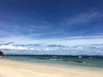 Scenic view of beach against blue sky