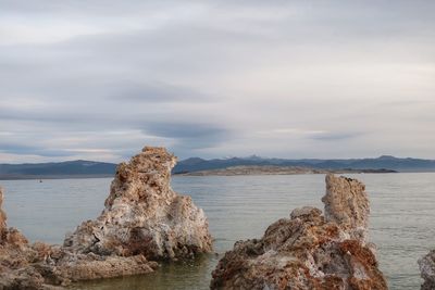 Rocks on shore against sky