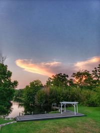 Scenic view of swimming field against sky during sunset