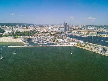 High angle view of buildings by sea against sky