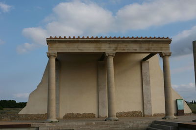 Low angle view of historical building against cloudy sky