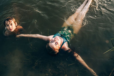 High angle view of kids swimming in lake