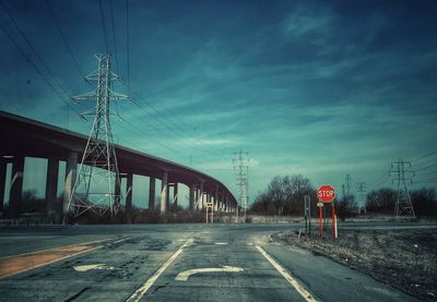Empty road against sky at sunset