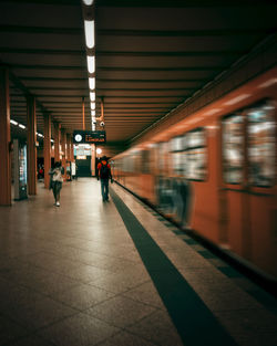 Rear view of woman walking in subway