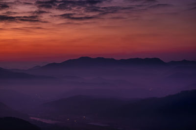Scenic view of silhouette mountains against the romantic sky at sunset