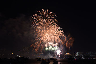 Firework display over city at night