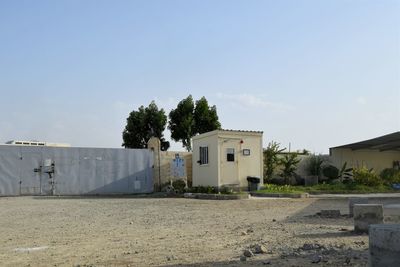 Abandoned building on field against sky