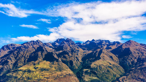 Scenic view of snowcapped mountains against blue sky