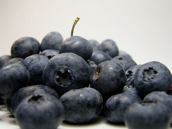 Close-up of blueberries against white background