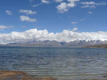 Scenic view of sea and mountains against sky