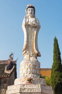 Low angle view of statue against sky