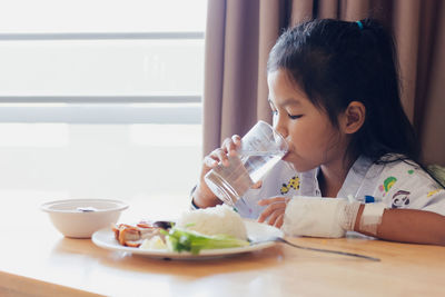 Mother and daughter on table at home