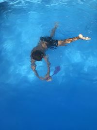 High angle view of a boy diving in pool