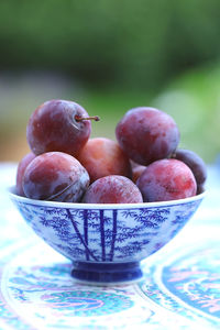 Plums in blue-white bowl