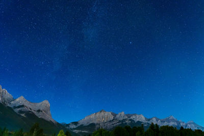 Starry sky with rocky mountains mount rundle in summer night.