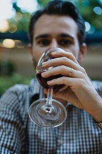 Close-up portrait of man drinking red wine