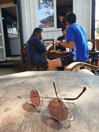 Rear view of people sitting on table