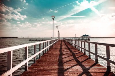 Pier over sea against sky