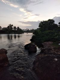 Scenic view of river against sky during sunset