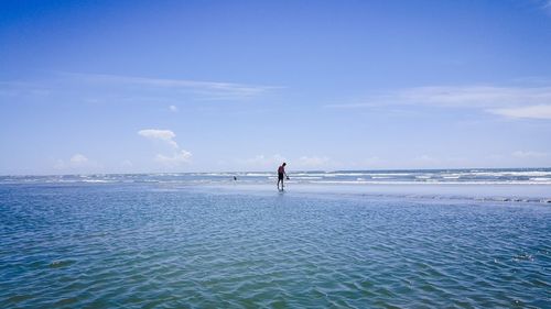 Man on beach against sky