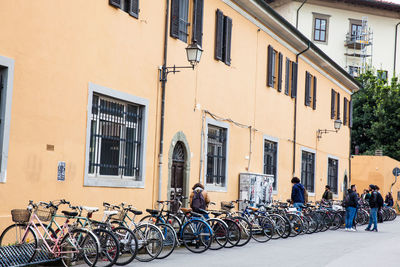 Bicycles parked on street against buildings in city