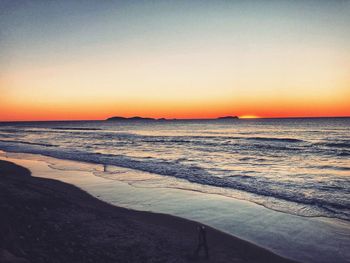 Scenic view of sea against clear sky during sunset