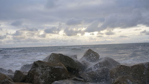 Scenic view of sea against cloudy sky