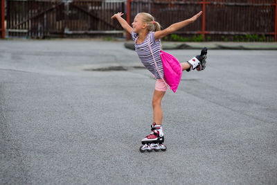 Girl roller skating on road