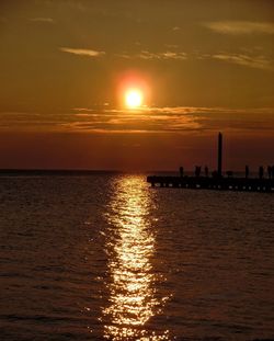 Scenic view of sea against orange sky