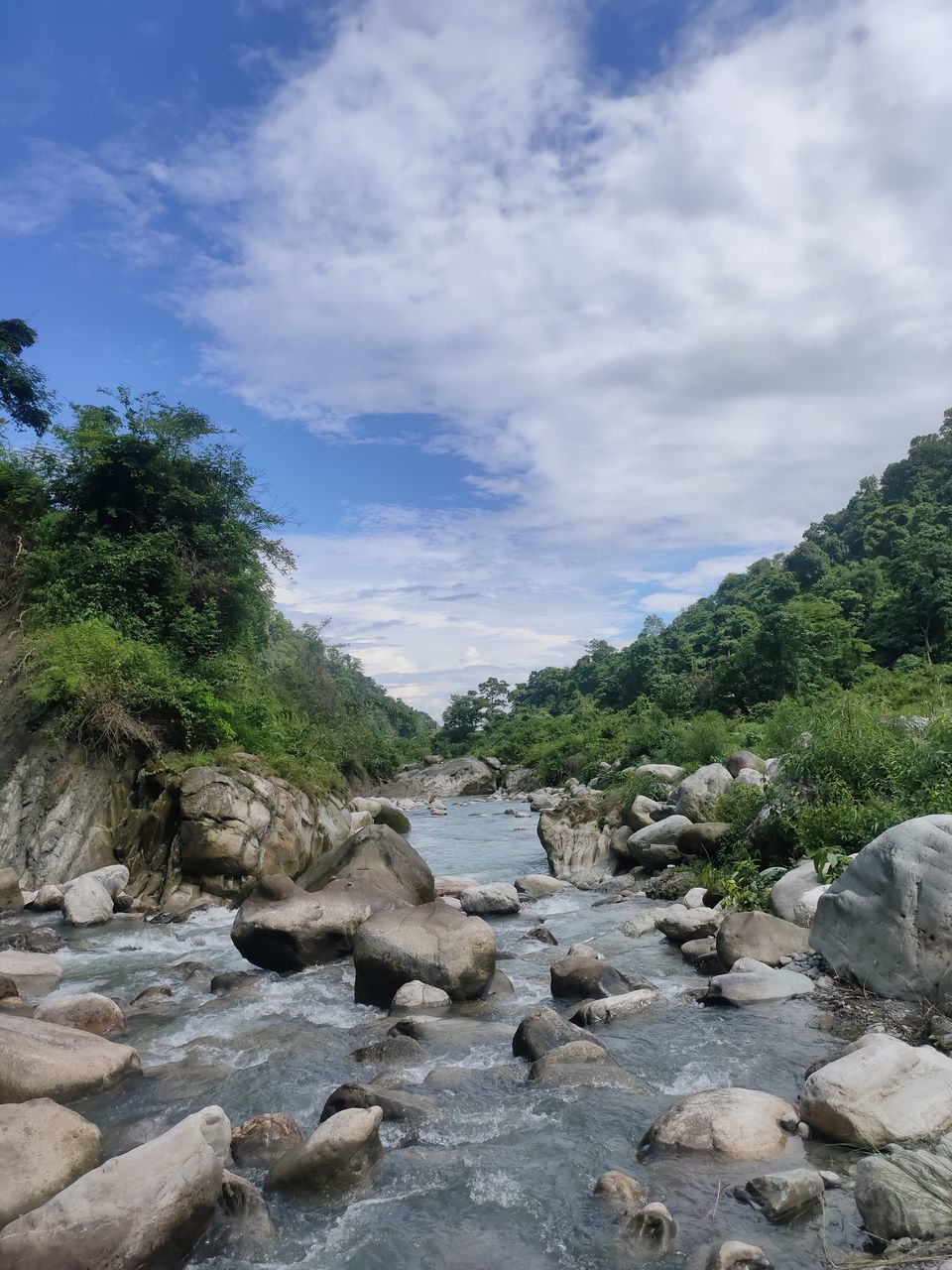 SCENIC VIEW OF WATERFALL AGAINST SKY