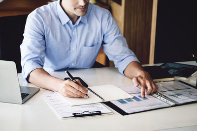 Midsection of business colleagues working at office