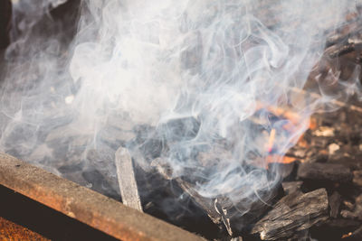 Close-up of smoke emitting from wood