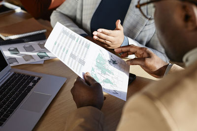 Business colleagues discussing over document in office