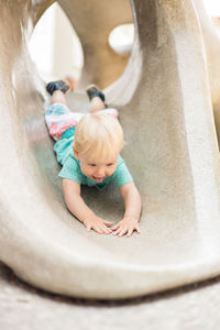 High angle view of girl playing in bathtub