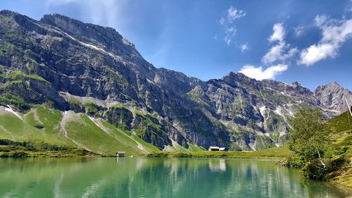 Scenic view of lake and mountains against sky