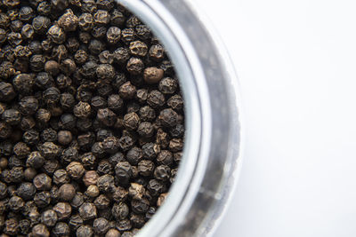 Black pepper on glass bowl.