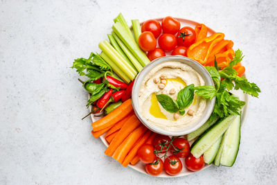 High angle view of vegetables in bowl against white background