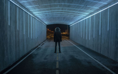 Full length of man standing in illuminated tunnel