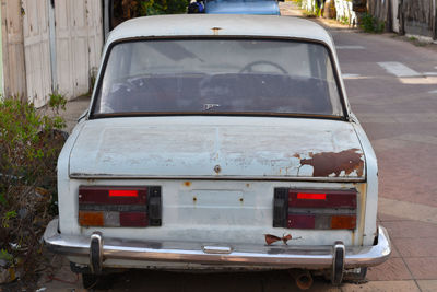 Close-up of abandoned car on street