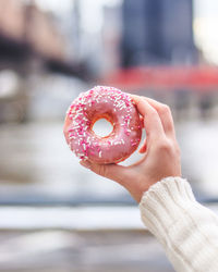 Close-up of hand holding donut