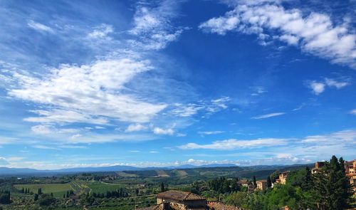 Panoramic view of trees and buildings against sky